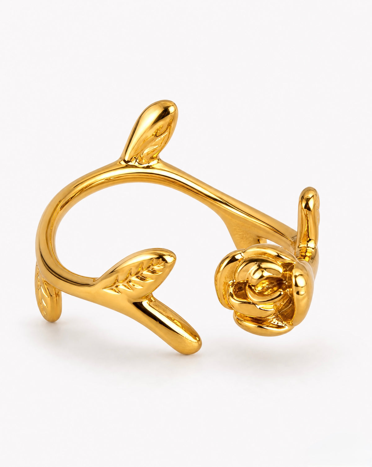 Gold ring with rose design on a white background