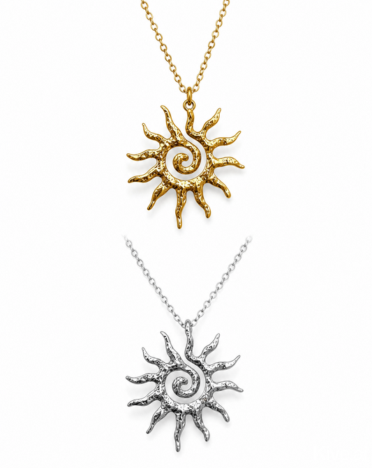 Two sun-shaped pendants, one gold and one silver, on white backgrounds.